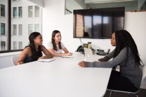  Three-girls-sitting-on-chairs-on-a-room